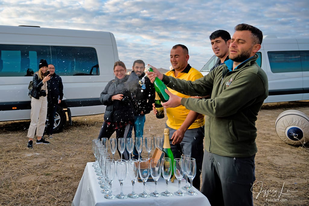 39. 7:16 am - Champagne Toast After the Flight (Our Pilot is Holding the Bottle)
